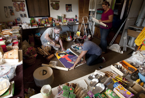 Steve Griffin  |  The Salt Lake Tribune
Robert Rowland, his daughter, Lisa Rowland, and niece Tiffany Morris sort through posters in the former home of his parents, Oscar and Beverly Rowland, in Salt Lake City Wednesday Aug. 27, 2013. The Avenues home has sat vacant for three years because the Rowlands' children were intimidated about how to handle its contents. The family's first attempt at unloading Oscar's vast collection will be Sept. 6-8, and it will take up a full eight rooms of his Avenues house. What they sell will make room for them to explore other rooms full of yet-to-be explored boxes.