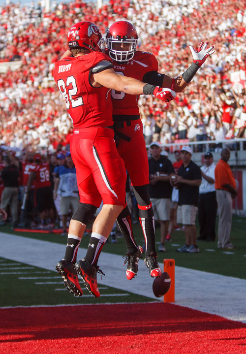 Trent Nelson  |  The Salt Lake Tribune
Utah Utes wide receiver Dres Anderson (6) celebrates a first quarter touchdown pass with Utah Utes tight end Jake Murphy (82) as the University of Utah hosts Utah State, college football Thursday, August 29, 2013 at Rice-Eccles Stadium in Salt Lake City.