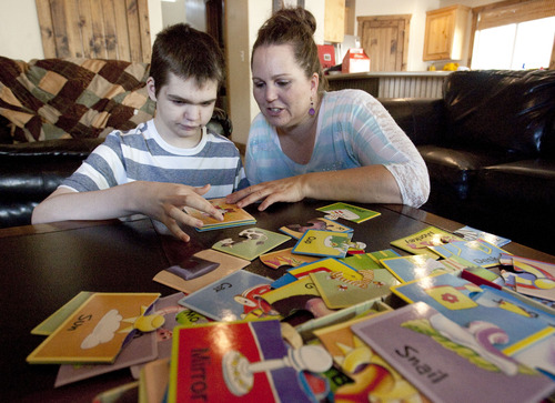 Steve Griffin | The Salt Lake Tribune

Jennifer May builds puzzles with her son, Stockton, at their .Pleasant Grove, Utah, home Tuesday Aug. 27, 2013.  Stockton, who has severe seizures, has tried 25 other treatments prescribed by doctors. Jennifer May now wants to try medical marijuana.