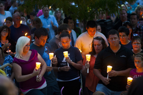 Chris Detrick  |  The Salt Lake Tribune
Surrounded by community members and friends, relatives of Sgt. Derek Johnson participate in a candlelight vigil forthe fallen officer at Draper City Hall Sunday, September 1, 2013. "This is a very tragic day for the Draper City Police Department," said Draper Police Chief Bryan Roberts.