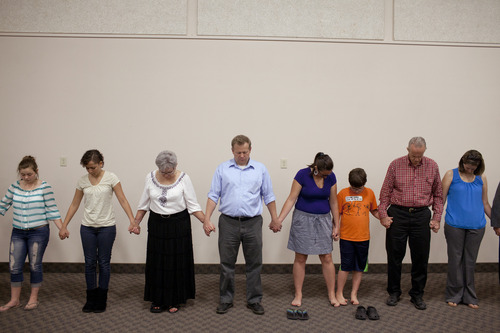 Jim McAuley | The Salt Lake Tribune
Members of the Midvalley Bible Church in Bluffdale, Utah, pray for their pastor, Ken Hornok, on Sunday, Aug. 25, 2013, after his last sermon in 39 years of service.