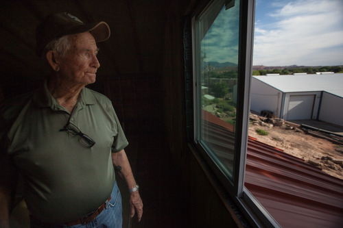 Trevor Christensen  |  Special to the Tribune

During a tour of Adelante Village, a women's shelter currently under construction by the Erin Kimball Memorial Foundation, Co-Founder of the organization Don Kimball looks out an apartment window at Dixie Gun Worx on Wednesday, August 21, 2013. Dixie GunWorx is a firearms and gunsmithing shop looking to put in a firing range near the shelter.