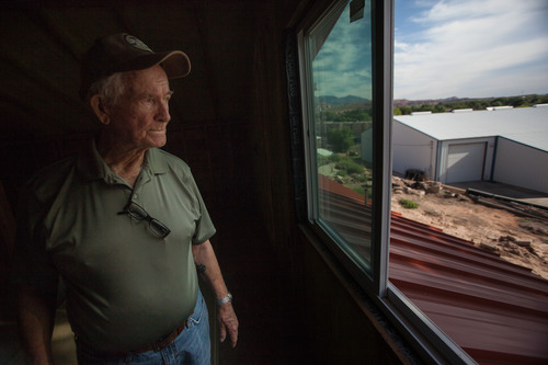 Trevor Christensen  |  Special to the Tribune

During a tour of Adelante Village, a women's shelter currently under construction by the Erin Kimball Memorial Foundation, Co-Founder of the organization Don Kimball looks out an apartment window at Dixie Gun Worx on Wednesday, August 21, 2013. Dixie GunWorx is a firearms and gunsmithing shop looking to put in a firing range near the shelter.