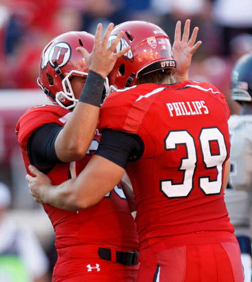 Trent Nelson  |  The Salt Lake Tribune
Utah Utes running back Marcus Williams (33) and kicker Andy Phillips (39) celebrate an extra point as the University of Utah hosts Utah State, college football Thursday, August 29, 2013 at Rice-Eccles Stadium in Salt Lake City.