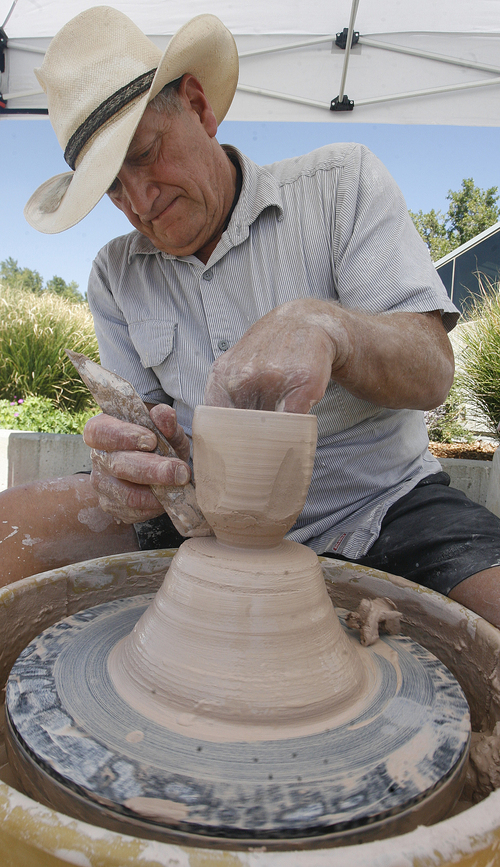 Scott Sommerdorf   |  The Salt Lake Tribune
Rick Moldover works clay into a cup as part of the University of Utah's College of Fine Arts' 3rd annual Arts Bash on the Library Plaza, Wednesday, September 4, 2013.