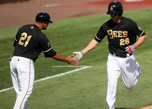 Kim Raff | The Salt Lake Tribune
Salt Lake Bees player (right) John Hester gets a hand from manager Keith Johnson after hitting a two-run home run against the Oklahoma City Redhawks at Spring Mobile Ballpark in Salt Lake City on Aug. 5, 2012. Of the 2012 season, Johnson said: "This group we had this year, even with the ups and downs, the guys continued to play hard. Our lineup got real thin at times. Our pitching staff got real thin at times, but the guys continued to battle through it."