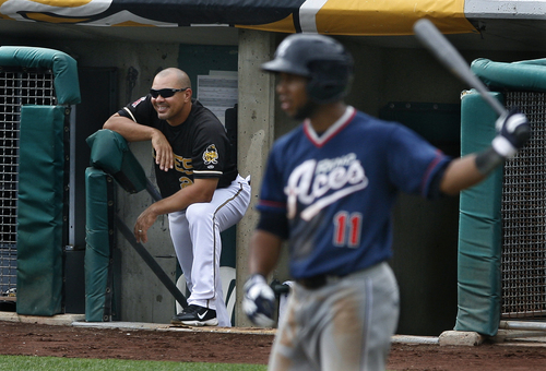 Scott Sommerdorf   |  The Salt Lake Tribune
Bees manager Keith Johnson chuckles at the response he got from one of his infielders after he gave him signs fromt he dugout during the Salt Lake Bees 10-7 loss to the Reno Aces, Sunday, September 1, 2013. The Aces' Alfredo Marte is coming to bat at right.