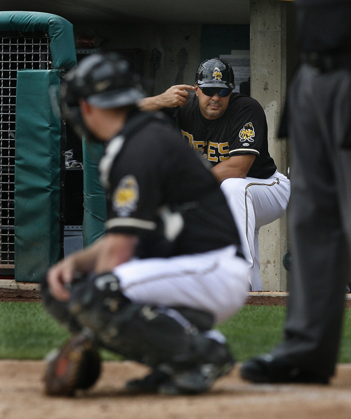 Scott Sommerdorf   |  The Salt Lake Tribune
Bees manager Keith Johnson sends in signs to catcher Luke Carlin during their 10-7 loss to the Reno Aces, Sunday, September 1, 2013.