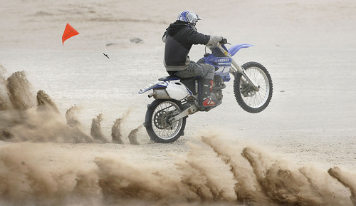 Scott Sommerdorf  |  Salt Lake Tribune
LITTLE SAHARA
A rider's paddle tires churn up the sand as it prepares to power up "Sand Mountain" at Little Sahara National Recreation Area, Saturday 4/3/10.