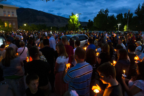 Family, friends, colleagues and community members participate in a candlelight vigil for Sgt. Derek Johnson at Draper City Hall Sunday Sept. 1, 2013. "This is a very tragic day for the Draper city police department," said Draper Police Chief Bryan Roberts. (AP Photo/The Salt Lake Tribune, Chris Detrick)