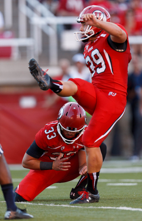 Trent Nelson  |  The Salt Lake Tribune
Utah Utes kicker Andy Phillips (39) scores an extra point, with running back Marcus Williams (33) holding the ball as the University of Utah hosts Utah State, college football Thursday, August 29, 2013 at Rice-Eccles Stadium in Salt Lake City.