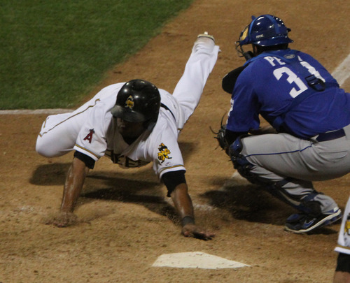 Rick Egan  | The Salt Lake Tribune 

Andy Marte dives into home for the winning run in the bottom of the 9th inning in playoff action Salt Lake Bees vs. The Las Vegas 51's at the Springmobile Ball Park, Wednesday, September 4, 2013. Marte scored from 3rd, on a fly out to centerfield.