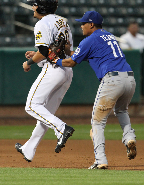 Rick Egan  | The Salt Lake Tribune 

Roberto Lopez is tagged out by Ruben Tejada, in playoff action Salt Lake Bees vs. The Las Vegas 51's at the Springmobile Ball Park, Wednesday, September 4, 2013.