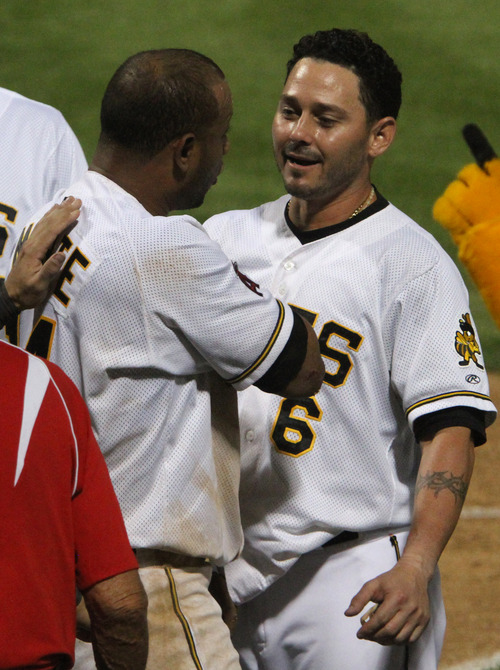 Rick Egan  | The Salt Lake Tribune 

Andy Marte (left) is congratulated by Luis Rodriguez after scoring the winning run in the bottom of the 9th inning in playoff action Salt Lake Bees vs. The Las Vegas 51's at the Springmobile Ball Park, Wednesday, September 4, 2013. Marte scored from 3rd, on a fly out to centerfield.