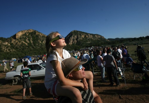 Kim Raff | The Salt Lake Tribune
(top) Marissa, (bottom) Jon Wikan watch the annular solar eclipse at the public viewing area in Kanarraville, Utah on May 20, 2012.
