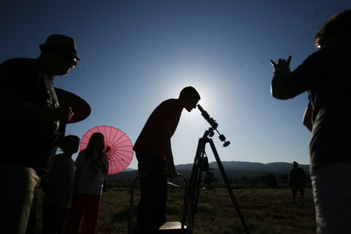 Kim Raff | The Salt Lake Tribune
Jake Rehkop looks through a telescope as people view the annular solar eclipse in Kanarraville, Utah on May 20, 2012. Kim Raff | The Salt Lake Tribune