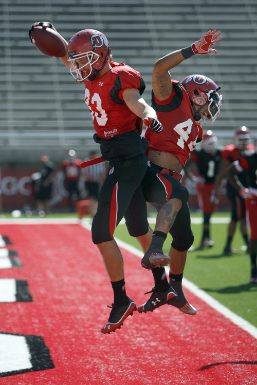 Francisco Kjolseth  |  The Salt Lake Tribune
Sean Fitzgerald, left, celebrates a touchdown with Lucky Radley as the University of Utah's football team holds their first preseason scrimmage at the stadium on Tuesday, August 13, 2013.