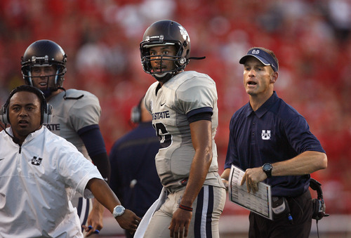 Scott Sommerdorf   |  The Salt Lake Tribune
Utah State QB Chuckie Keeton walks to the sideline after his TD toss to give USU a 17-14 halftime lead over Utah, as head coach Matt Wells tries to get his celebrating players behind the sidelines, Thursday, August 29, 2013.