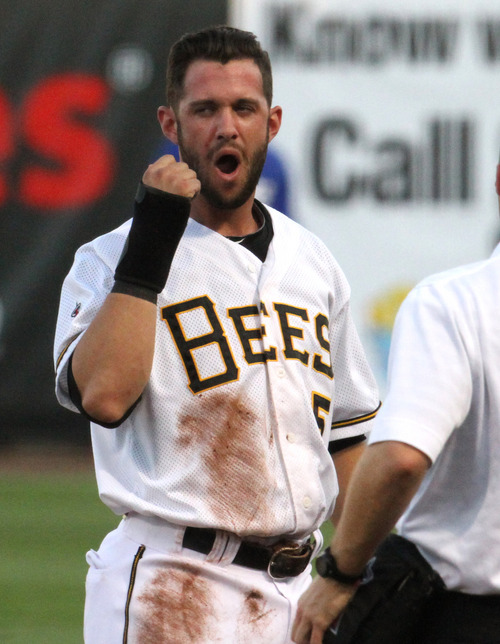 Rick Egan  | The Salt Lake Tribune 

Matt Long checks his jaw after being hit in the head by a throw on a pick off play,  in playoff action Salt Lake Bees vs. The Las Vegas 51's at the Springmobile Ball Park, Wednesday, September 4, 2013.