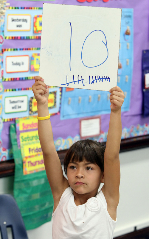 Rick Egan  | The Salt Lake Tribune 

Zhania Gomez holds up her answer in Claire Maliejewski's first grade class at Polk Elementry School, Wednesday, September 4, 2013. Lawmakers who support Utah's new system for giving letter grades to schools point to Polk Elementary, which received a 'B' grade, as a success story.