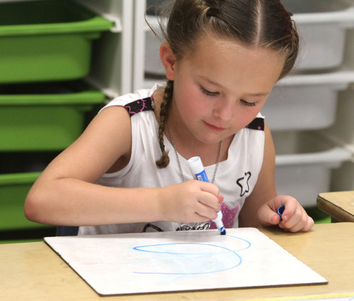 Rick Egan  | The Salt Lake Tribune 

Cienna Parsons concentrates on her assignment at Polk Elementry School, Wednesday, September 4, 2013. Lawmakers who support Utah's new system for giving letter grades to schools point to Polk Elementary, which received a 'B' grade, as a success story.