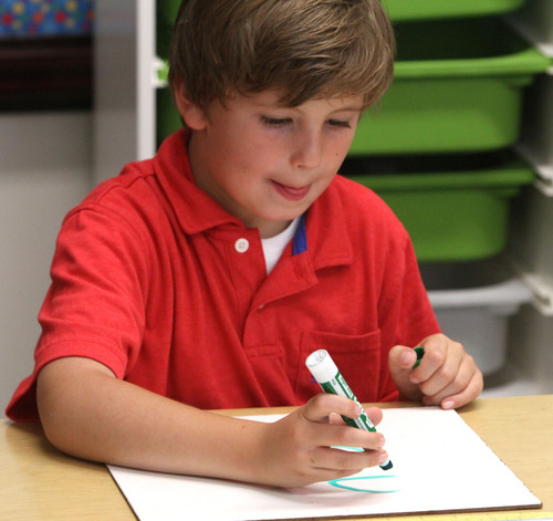 Rick Egan  | The Salt Lake Tribune 

FIrst grade, Charlie Gaskill concentrates on his assignment at Polk Elementry School, Wednesday, September 4, 2013.  Lawmakers who support Utah's new system for giving letter grades to schools point to Polk Elementary, which received a 'B' grade, as a success story.