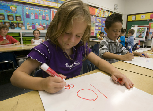 Rick Egan  | The Salt Lake Tribune 

Bree Van Etten and Joel Gomez draw numbers in Claire Maliejewski's first grade class, Wednesday, September 4, 2013.  Lawmakers who support Utah's new system for giving letter grades to schools point to Polk Elementary, which received a ëBí grade, as a success story.