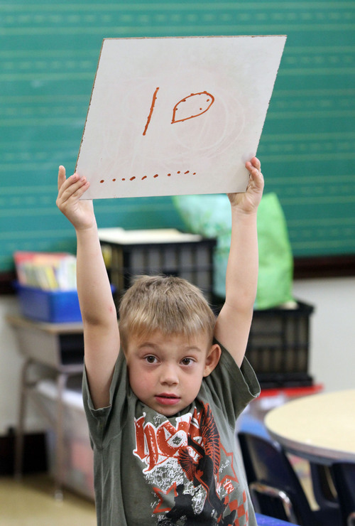 Rick Egan  | The Salt Lake Tribune 

Xavion Ruker holds up his answer in Claire Maliejewski's first grade class, at Polk Elementry School, Wednesday, September 4, 2013.  Lawmakers who support Utah's new system for giving letter grades to schools point to Polk Elementary, which received a ëBí grade, as a success story.
