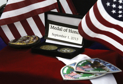 Rick Egan  | The Salt Lake Tribune 

Medal of Honor on display at the funeral for Derek Johnson at the Maverick Center, Friday, September 6, 2013.