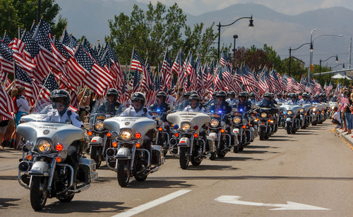 Trent Nelson  |  The Salt Lake Tribune
Flags fly as the funeral procession for Sgt. Derek Johnson, the Draper police officer who was shot to death on Sunday morning, passes through Draper Friday, September 6, 2013.