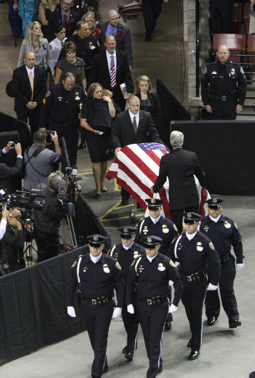 Rick Egan  | The Salt Lake Tribune 

The casket is brought into the Maverick Center for the funeral for Derek Johnson, Friday, September 6, 2013.