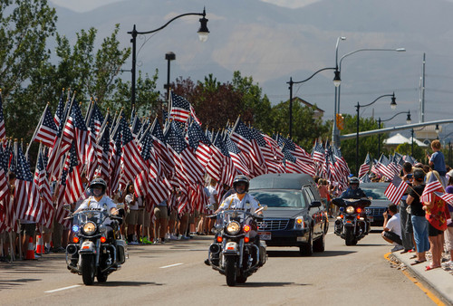 Trent Nelson  |  The Salt Lake Tribune
Flags fly as the funeral procession for Sgt. Derek Johnson, the Draper police officer who was shot to death on Sunday morning, passes through Draper Friday, September 6, 2013.