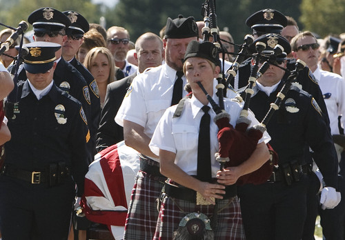 Leah Hogsten | The Salt Lake Tribune
Family, friends and coworkers follow the casket of Draper Police Sgt. Derek Johnson who was laid to rest at Larkin Sunset Mortuary, September 6, 2013. Sgt. Johnson was shot by a transient after the 32-year-old officer pulled up in his patrol car to investigate the man's vehicle. The suspect, Timothy Troy Walker, then shot his passenger, Traci Vaillancourt, and himself.