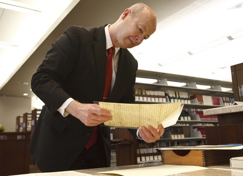Leah Hogsten | The Salt Lake Tribune
Richard Turley, Assistant Church Historian and Recorder, holds one of Joseph Smith's personal documents during a press conference to announce the inaugural release of the church's Documents Series, Volume 1: July 1828-June 183, at the LDS Church History Library, September 4, 2013.  It is part of the multi-volume Joseph Smith Papers Project. Historic documents in this series include Joseph Smithís revelations, reports of his discourses and personal letters both sent and received. Also in the collection are articles Joseph Smith wrote for newspapers, minutes of his meetings, and Church administrative records.