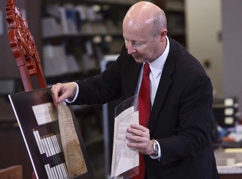 Leah Hogsten | The Salt Lake Tribune
Richard Turley, Assistant Church Historian and Recorder, holds one of Joseph Smith's personal documents during a press conference to announce the inaugural release of the The Joseph Smith Papers Project's Documents Series, Volume 1: July 1828-June 1831 book at the LDS Church History Library, September 4, 2013.   Historic documents in this series include Joseph Smith's revelations, reports of his discourses and personal letters both sent and received. Also in the collection are articles Joseph Smith wrote for newspapers, minutes of his meetings, and Church administrative records.