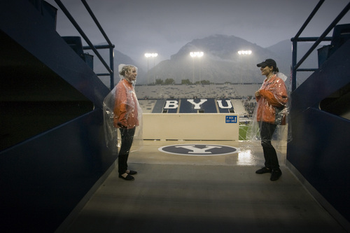 Rick Egan  | The Salt Lake Tribune 

BYU ushers stand guard in the west stands, as fans were told to seek cover from the rain and lightening, as a huge rainstorm hit Lavell Edwrds stadium, an hour before game time, as BYU prepared to face the University of Texas, Saturday, September 7, 2013. The game was delayed due to lightening.
