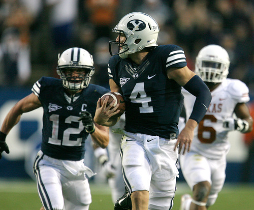 Rick Egan  | The Salt Lake Tribune 

 Brigham Young Cougars quarterback Taysom Hill (4) looks over his shoulder as he runs for a 68 yard touchdown as BYU played the University of Texas, Lavell Edwards stadium, Saturday, September 7, 2013.