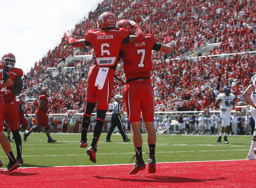 Scott Sommerdorf   |  The Salt Lake Tribune
Utah Utes wide receiver Dres Anderson (6) celebrates with QB Travis Wilson after his 51 yard TD run. Utah cruised to a 49-0 halftime lead over Weber State, Saturday, September 7, 2013.