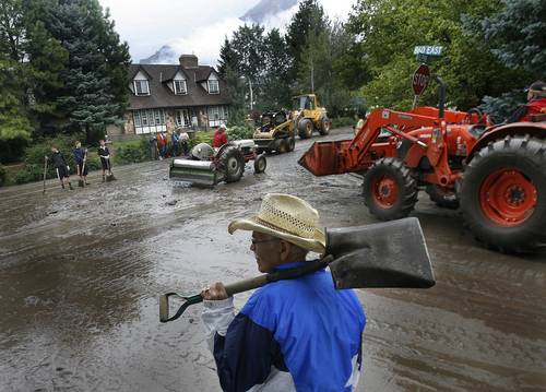 Scott Sommerdorf   |  The Salt Lake Tribune
Volunteers including John Lilly help clean up mud that flowed down Alpine Blvd at the intersection of Alpine and 860 East after mudslides in Alpine, Sunday, September 8, 2013.