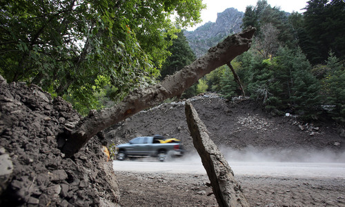 Francisco Kjolseth  |  The Salt Lake Tribune
Piles of debris have been pushed off the road in American Fork Canyon near Timpanogos Cave following heavy rains. Deep cuts of rock, mud and trees loom over the road edges where crews have been as they scramble to get ready for more possible rain in the forecast.