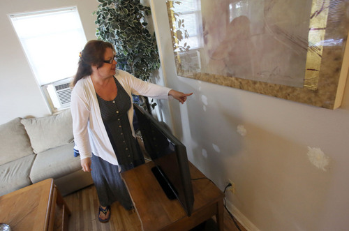 Francisco Kjolseth  |  The Salt Lake Tribune
Deborah Preste points out the patched bullet holes in the wall created by 20 officers who descended on her son's home to serve a no-knock warrant. Her son Alex Opmanis, now 21, shot at police with non-lethal bullets. Opmanis who didn't know who was on the other side of the door, and thought it was a group of Polynesian men there to rob him, immediately surrendered when he found out it was police.