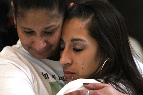 Rick Egan  | The Salt Lake Tribune 

Susana Rivera, left,  comforts her niece, Ashley Quintana at the Utah State Capitol,  Wednesday, March 6, 2013.  Quintana had her son taken away by DCFS and adopted out.
