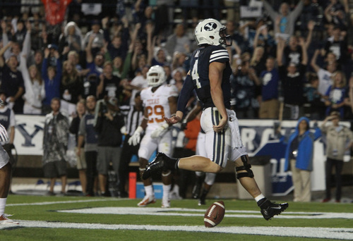 Rick Egan  | The Salt Lake Tribune 

 Brigham Young Cougars quarterback Taysom Hill (4) scores his second touchdown of the night as BYU played the University of Texas, Lavell Edwards stadium, Saturday, September 7, 2013.