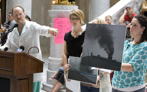 Paul Fraughton  |   The Salt Lake Tribune
Dr. Brain Moench points to a photo held by Sarah Sargent showing an emergency bypass event at the Stericycle medical waste incinerator in North Salt Lake. Clean-air advocates joined other concerned citizens at a rally in the Capitol rotunda Wednesday, Sept., 11, 2013, to voice their demand that the incinerator be shut down.