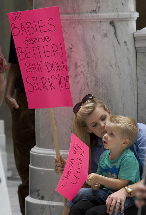 Paul Fraughton  |   The Salt Lake Tribune
Residenst of the Foxboro subdivision in North Salt Lake, Ginny Butler and her son Finn, age 3,  hold signs expressing their  feelings about Stericycle's medical waste incinerator in  North Salt Lake. The mother and son  were part of a rally in the rotunda of the state Capitol Wednesday, Sept. 11, 2013, to voice their demand that the incinerator be shut down.