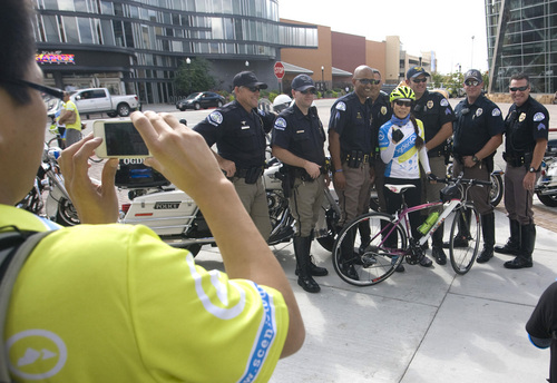 Rick Egan  | The Salt Lake Tribune 

Michelle Wang has her picture taken with Ogden City policemen. Wang is one of sixteen Taiwanese bicycle riders from Taiwan manufacturers that will be riding her bike up Ogden Canyon, Wednesday, September 11, 2013.