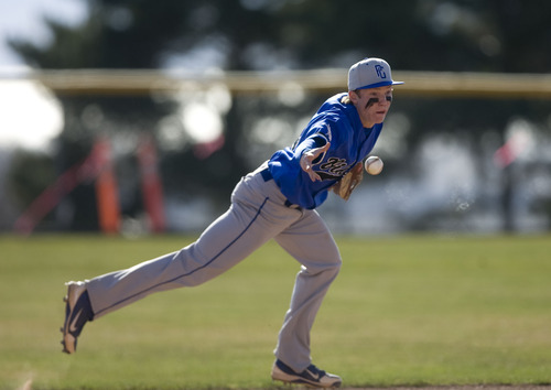Kim Raff  |  The Salt Lake Tribune
Pleasant Grove infielder Easton Walker tosses the ball to second after picking up a ground ball during a game against Alta at Pleasant Grove High School on March 21, 2013.
