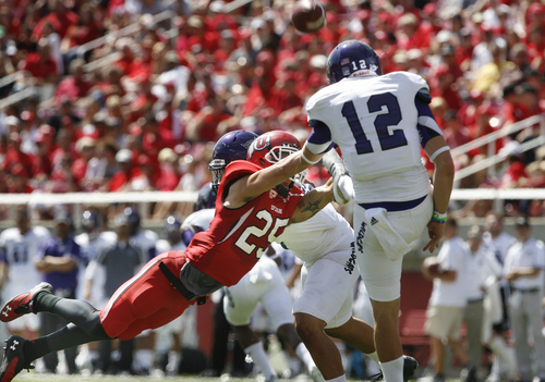 Utah defensive back Mike Honeycutt (25) nearly blocked this punt by Weber State punter Tony Epperson (12) during the first half of an NCAA college football game on Saturday, Sept. 7, 2013 in Salt Lake City.  Utah defeated Weber State 70-7.  (AP Photo/The Salt Lake Tribune, Scott Sommerdorf)  DESERET NEWS OUT; LOCAL TV OUT; MAGS OUT