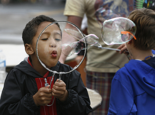 Scott Sommerdorf   |  The Salt Lake Tribune
Zachary Burke makes huge soap bubbles at the 9th and 9th street festival, in Salt Lake City, Saturday, September 12, 2013.