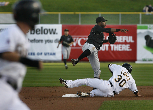 Scott Sommerdorf   |  The Salt Lake Tribune
Omaha 2B Christian Colon starts a double play forcing the Bees Roberto Lopez at second base. The Bees are trailing 4-2 in game 4 of the PCL Championship Series against the Omaha Storm Chasers, in the sixth inning, Saturday, September 14, 2013.